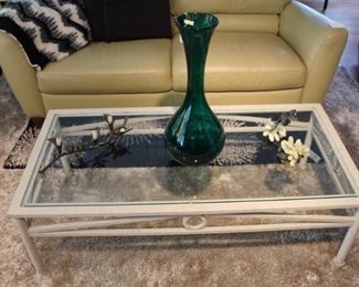 Glass top coffee table, leather sofa, and large Blenko  glass vase.  