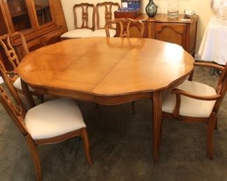 Dining room table with six chairs and two leaves.  