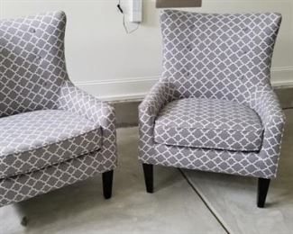 (2) gray upholstered chairs priced individually.