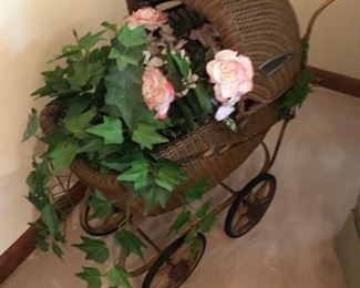 doll buggy serving as plant holder