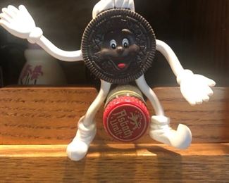 I could look at this photo for an hour and still not figure out what it is!!  Maybe Mr. Oreo riding a beer bottle?  