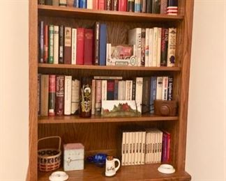 This is a super duper bookshelf, with a rail on top so things don't go flying, cabinet doors on the bottom and great display space - I believe it's cherry in a honey finish.  