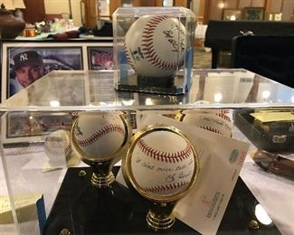 Signed and authenticated baseballs in acrylic cases. Silent Auction. 