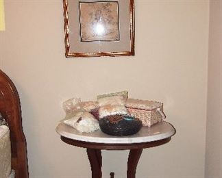 Vintage Marble Top table covered with laces and sewing baskets