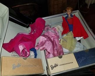 Barbie case inside and a collection of vintage Barbie clothes and of course Barbie her self