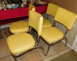 four yellow vintage dining chairs