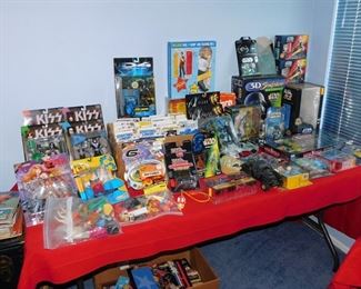 Large collection of Action figures still in package including Spawn, Kiss, X-Files, Batman, Starting Line up, X-Men and more