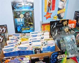 Large collection of Action figures still in package including Spawn, Kiss, X-Files, Batman, Starting Line up, X-Men and more