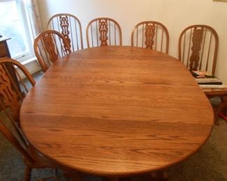This is a beautiful pedestal table with 6 chairs