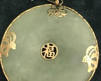 Large 14K and jade pendant. Has matching earrings.