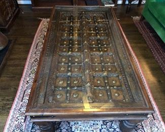 Arabic door converted into glass top coffee table. Measures 34” x 66 1/4” in length x 17 3/4” tall.