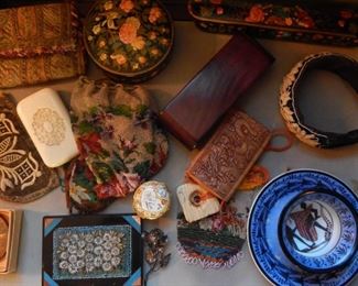 Display table with many boxes and china art.