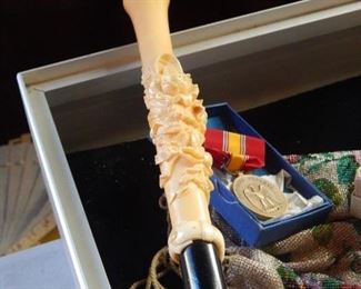 Ivory cane handle.