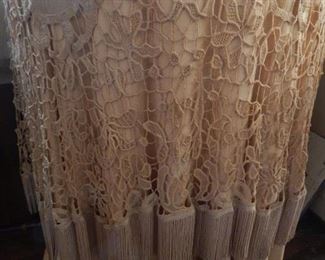 Round table with lace table linen.
