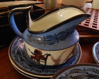 OLD cups and saucers with one creamer.