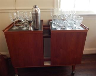 Mid Century bar on wheels. Really nice piece and it can be floated in the room because it is finished all around.