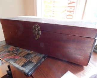 Wooden box with chess players inside.