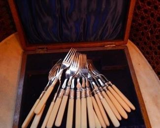 Silver forks with celluloid handles.