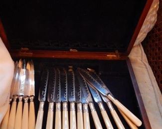 Silver knives with celluloid handles.