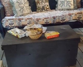 Vintage wicker sofa and wooden carpenter's chest