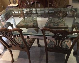 Vintage Milo Baughman-style glass and polished steel and brass dining table with pull out extension leaves , all tempered glass and polished stainless steel, surrounded by a set of 8  Chippendale reproduction dining chairs 