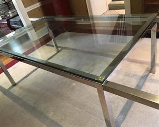 Vintage Milo Baughman style glass and polished stainless steel dining table with pull out extensions and 2 glass leaves, closed measures 6' by 42" wide and with two leaves a 9' total.