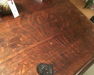 Detail: heart shape burn mark on English quarter sewn oak antiqure table with dovetailed drawers