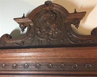 Detail: carved cherub on topper of quarter-sewn oak and marble washstand vanity