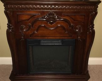 Cherry finish electric fireplace.