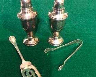 Silver salt and pepper and serving tools.