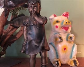 chalkware piggy bank and old bronze statue