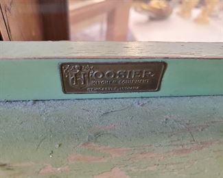 Hoosier cabinet tag on top of child sized cabinet.