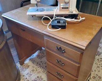 Walnut sewing cabinet and Necchi sewing machine.