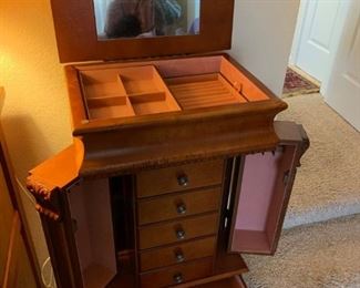 Standing jewelry cabinet, closes to look like a chest of drawers.