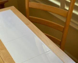 Blonde wood/tile kitchen table with four chairs, sides fold up in lieu of a leaf.
