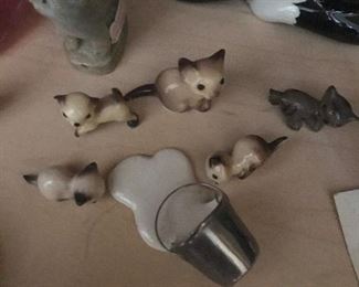 Siamese cats with bucket of spilled milk. 