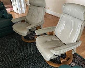 Pair of DANIA Stressless leather recliners with matching ottomans