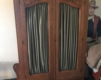 Located in the Den, this Oak Knock-down Wardrobe has fabric panels which can be customized to fit your decor.