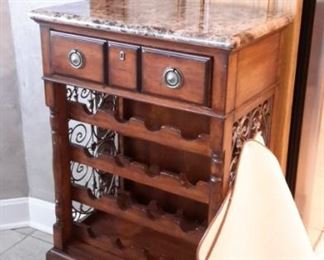 Marble top wine storage with one drawer.