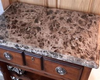 Marble top wine storage with one drawer.