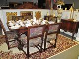 Antique Oak table with extendable side leaves (extends to 10') Six upholstered oak chairs. China Porcelain set.