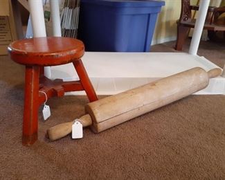 Large rolling pin and red-painted milking stool