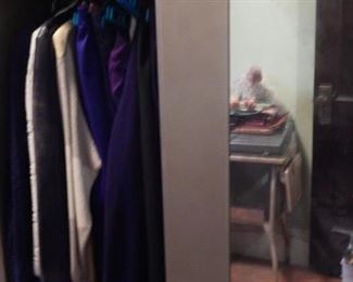 Mirrored front portable metal clothing cabinet.