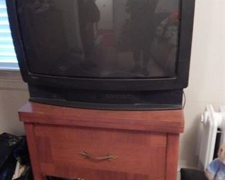 Old tv on a sewing machine table.
