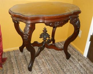 1920s Unique Intricate carved mahogany side table with glass top. 4' high