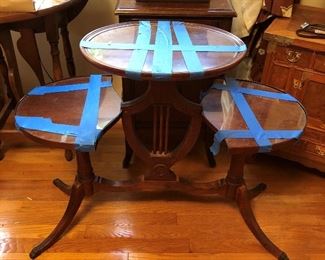 Interesting antique three-tiered table -- the blue tape is holding the glass tops in place.