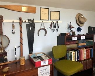 Office Chairs, Cassette Tapes, CD's and DVD's. Homemade Saw musical instrument. Horse shoes, Spurs.