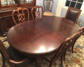 Wide shot of Thomasville Fredericksburg Mahogany with Rosewood inlay table 8 chairs with leaf
