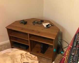 Corner TV stand with xbox, controllers and video games