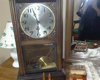 Mantle clock, WWII shells, arrowhead, pocket knife collection, and fountain pens